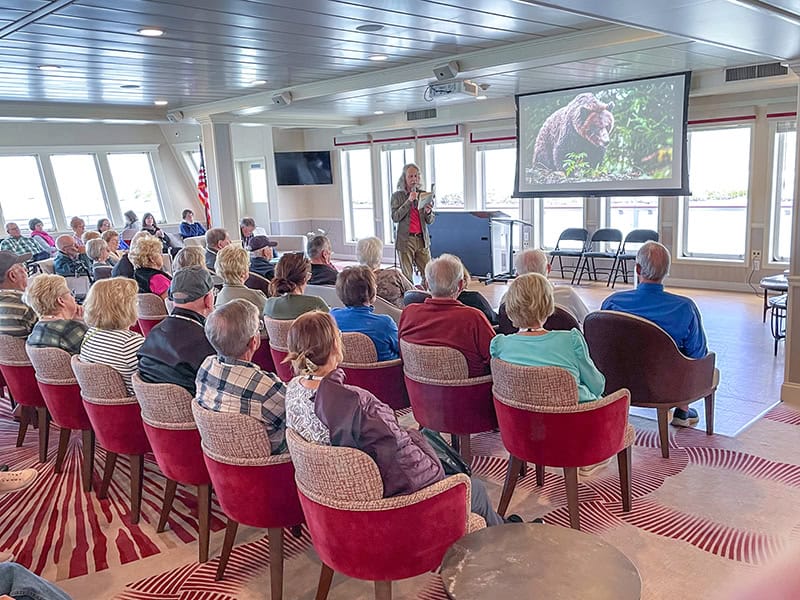 people on an during American Cruise Lines Lewis and Clark tour listening to a lecture