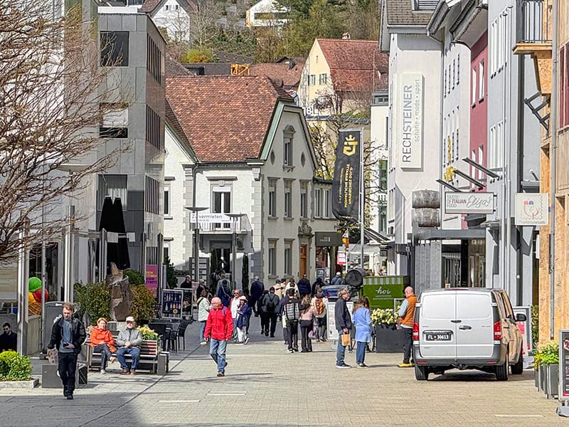 people on a street lined with old buildings in Liechtenstein