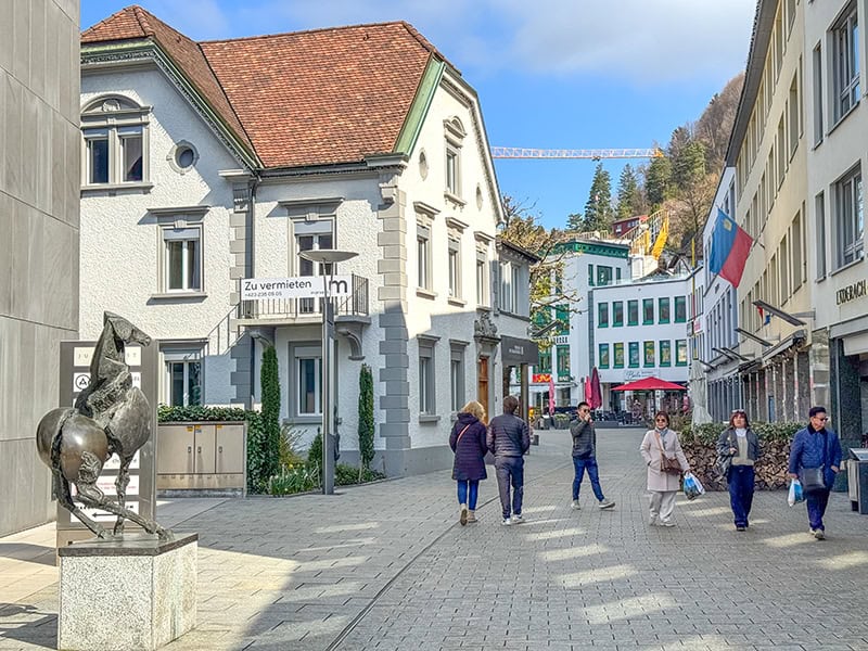 people walking along a street lined with old buildings in Liechtenstein