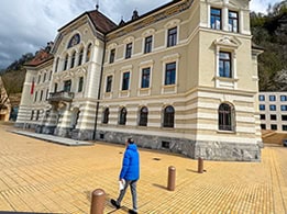 a many walking past the Parliament building