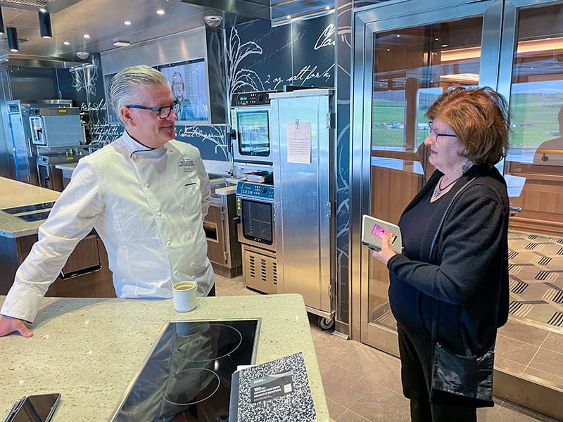 a chef talking with a woman
