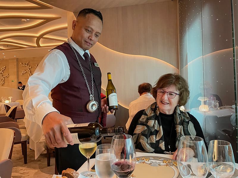 a waiter poring wine