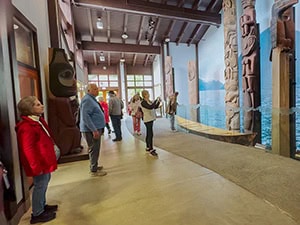 people looking at totem poles