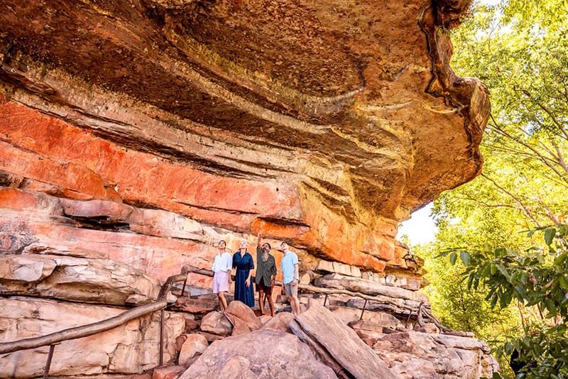 people looking at rock paintings