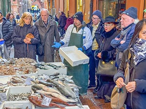 people buying fish at a market
