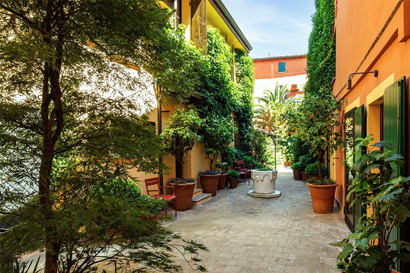 a walkway in a hotel garden