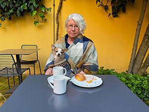 a woman with a dog in her lap