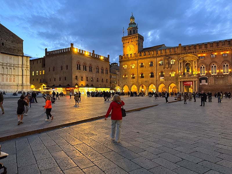 evening on a large ancient piazza in Bologna Italy