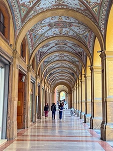 people walking in a portico in Bologna Italy