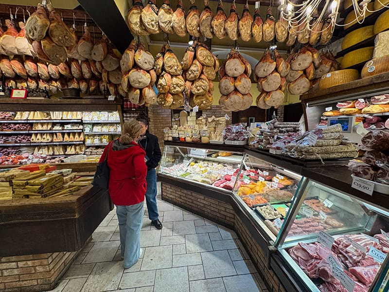 2 women in a food store in Bologna Italy