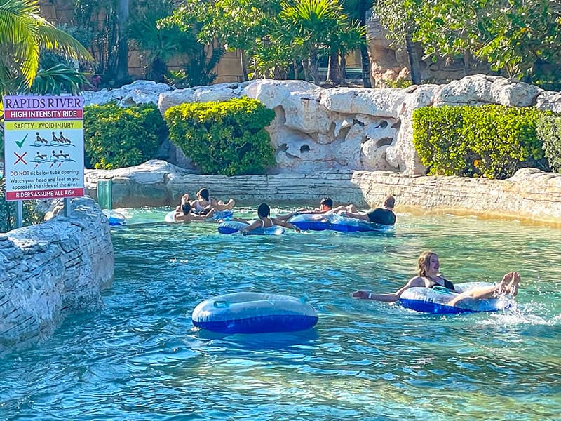 people tubing down a river - review of atlantis bahamas