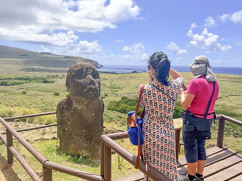 2 woman looking at a Moai on Easter Island Chile