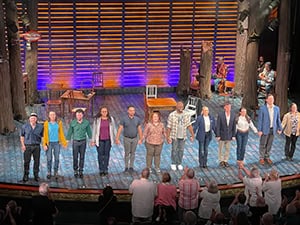 actors being applauded in a theater