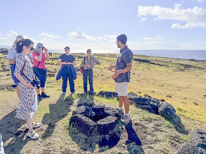 a group of people standing by a firepit
