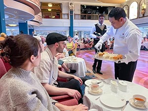people enjoying afternoon tea on a Cunard queen Elizabeth Caribbean cruise 