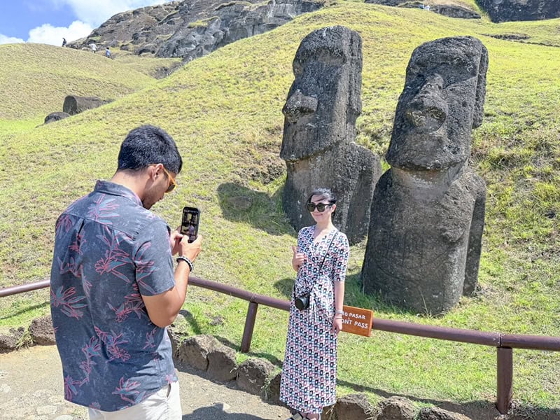 a man taking a photo of a woman on Easter Island Chile