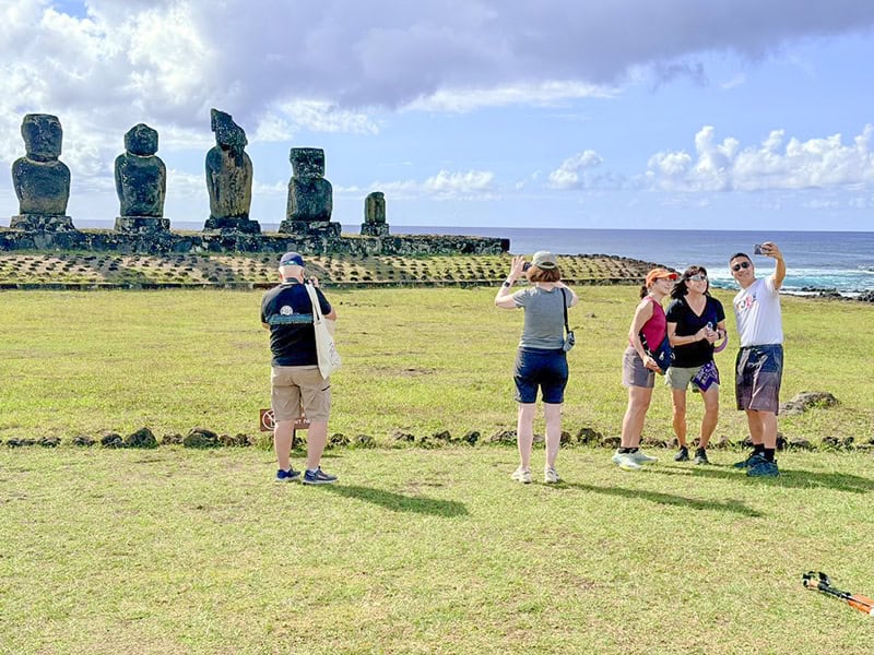 people taking photos of Moai