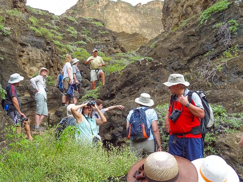 people hiking through montains in teh Galapagos Islands
