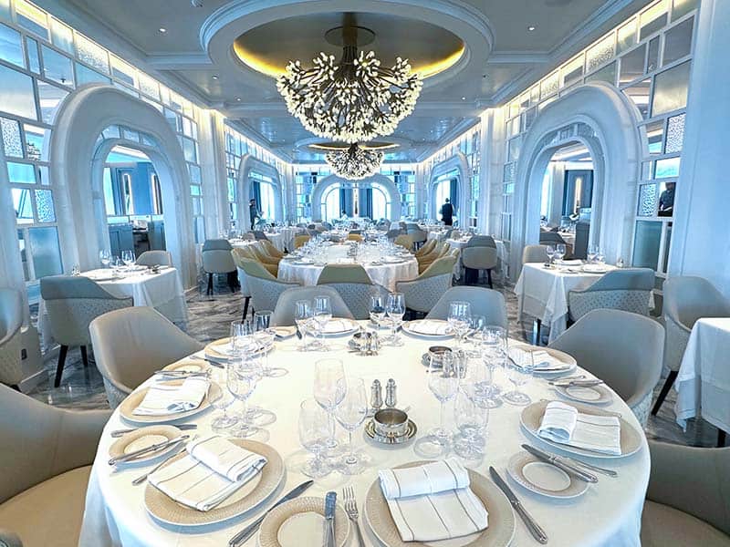 a large restaurant with all white tables and furniture