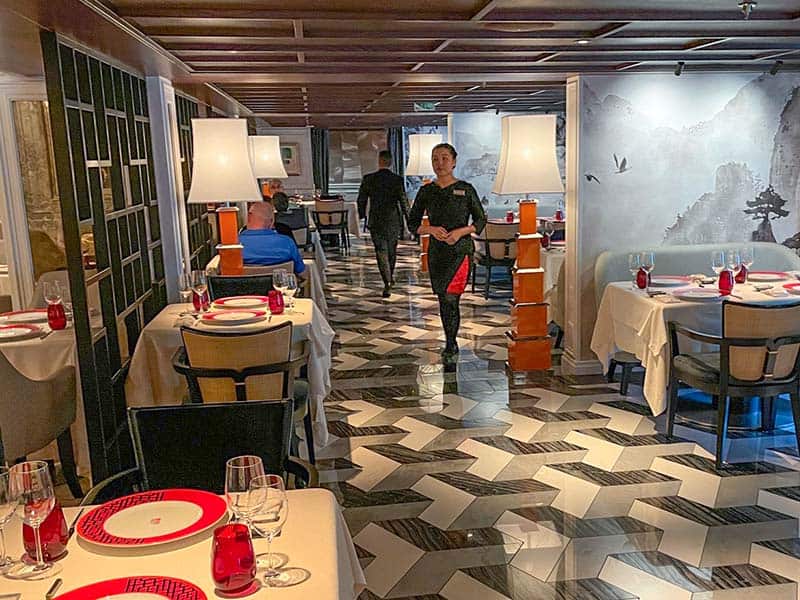 people walking through a restaurant on the Oceania Allura